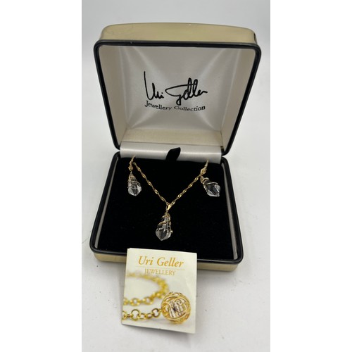 430 - A Uri Geller 9 carat gold and crystal earrings and matching necklace. In original presentation box. ... 