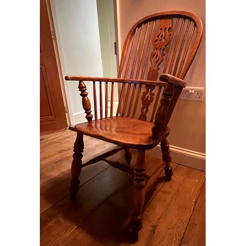 21 - A 19thC high backed ash and elm Windsor armchair. 105cm h to back.