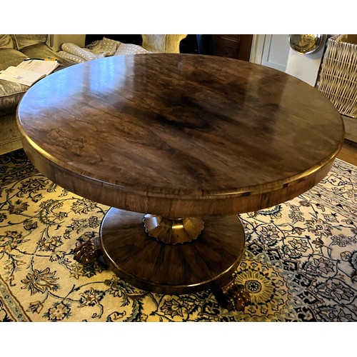 22 - A 19thC rosewood tip-top centre table with lions paw feet. 105cm d x 72cm h.