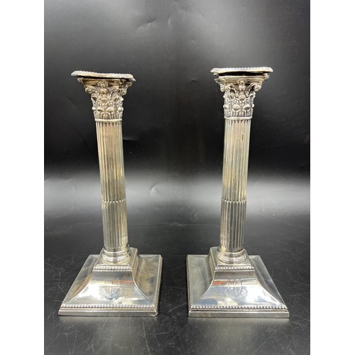 667 - A pair of Corinthian column silver candlesticks 28cm h. weighted bases. London 1884, Sheffield 1886,... 