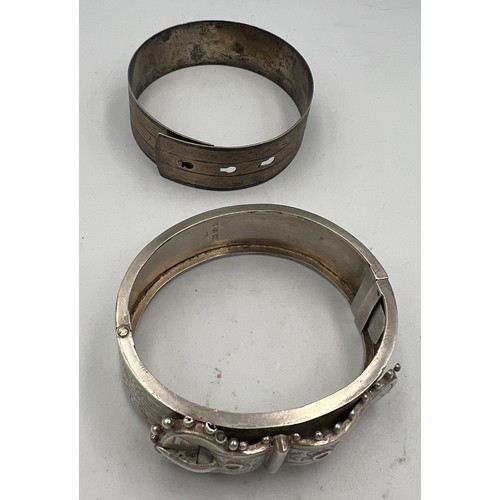 424 - A Victorian silver buckle bangle Birmingham 1885 together with an unmarked white metal bangle. Victo... 