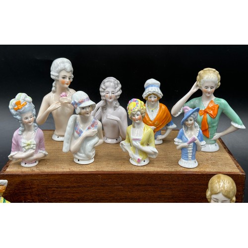 201 - A collection of 19th and early 20thC porcelain half dolls, tallest 12cm, smallest 5cm, some marked w... 