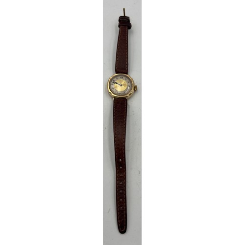 534 - A 9 carat gold cased ladies wristwatch on brown leather strap.