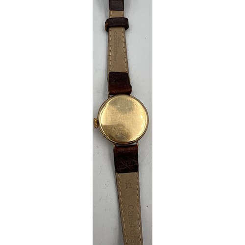 534 - A 9 carat gold cased ladies wristwatch on brown leather strap.