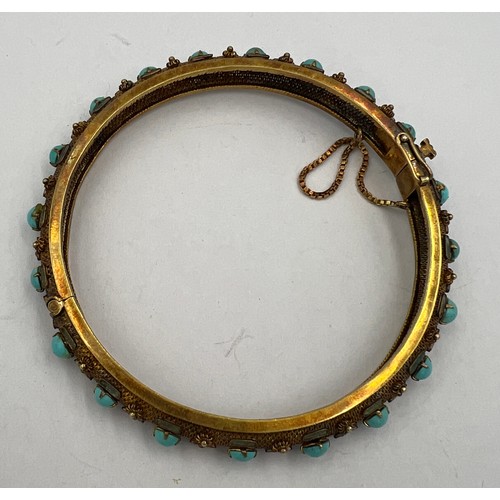 350 - A Chinese 14 carat yellow gold bangle set with turquoise and enamel. 7cm diameter. Weight 22.2gm.