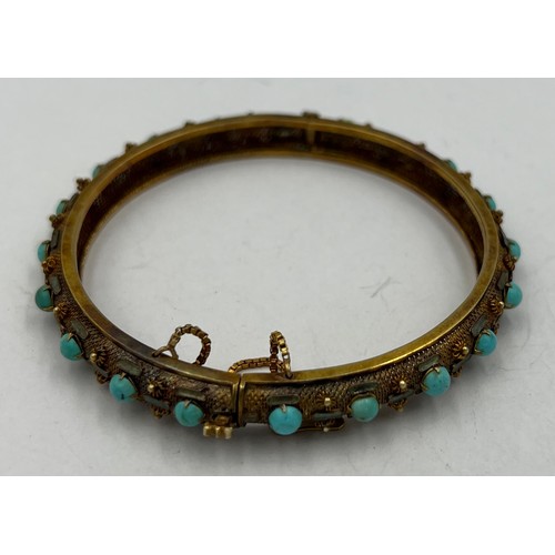 350 - A Chinese 14 carat yellow gold bangle set with turquoise and enamel. 7cm diameter. Weight 22.2gm.