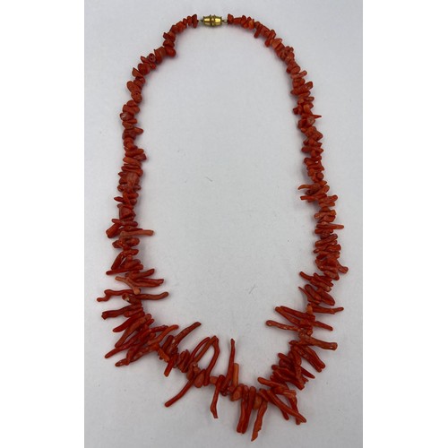 351 - A coral necklace, 52cm l, weight 38gm with yellow metal barrel fastening.