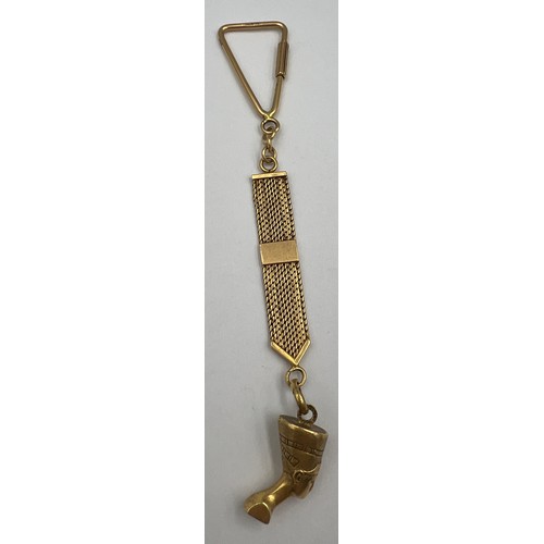 354 - An 18 carat gold key ring with Egyptian head charm, weight 18.1gm. 14cm l.