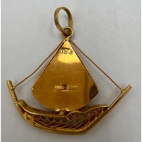 355 - An 18 carat yellow gold filigree sailboat charm. Weight 5.5gm.