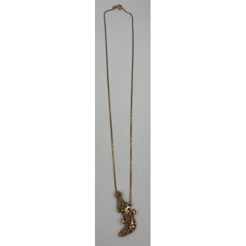 359 - An 18 carat yellow gold knife pendant on a fine 18 carat gold chain. Total weight 9.1gm.