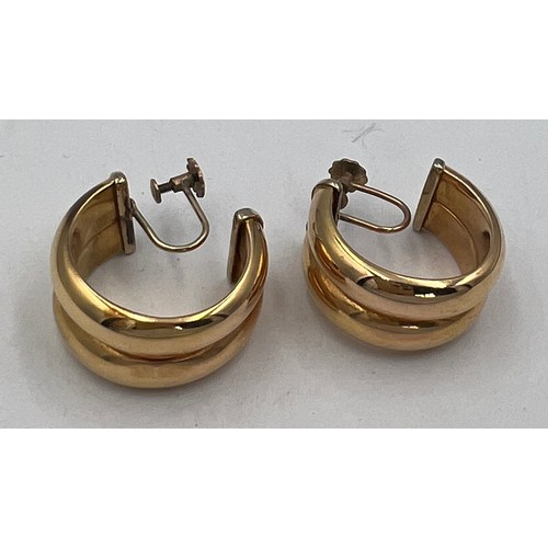 371 - A pair of half hoop screw on earrings, marked 9 carat to screw end. Hoop unmarked. Weight 9.5gm.