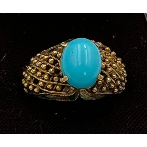 373 - A 14 carat gold ring set with turquoise stone with enamel decoration to the sides. Size N, weight 6.... 