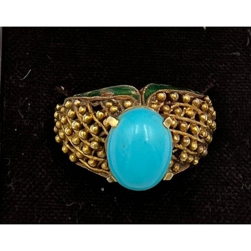 373 - A 14 carat gold ring set with turquoise stone with enamel decoration to the sides. Size N, weight 6.... 