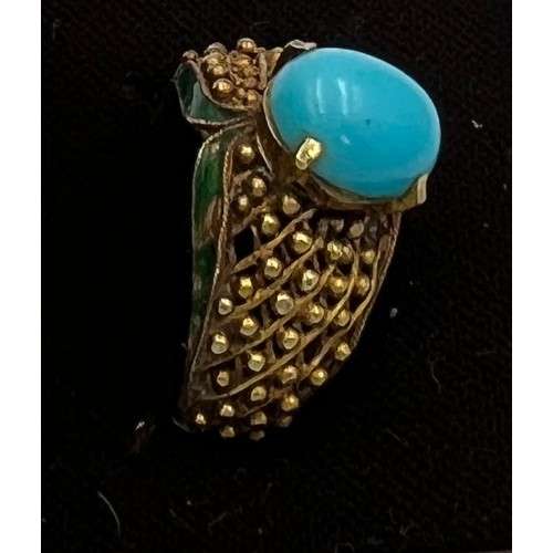 373 - A 14 carat gold ring set with turquoise stone with enamel decoration to the sides. Size N, weight 6.... 