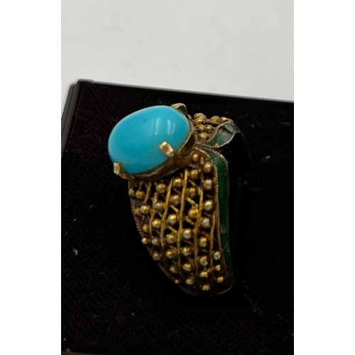 373 - A 14 carat gold ring set with turquoise stone with enamel decoration to the sides. Size N, weight 6.... 