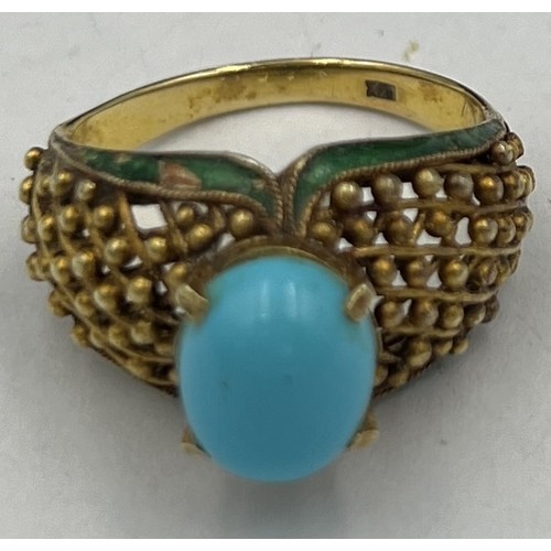 373 - A 14 carat gold ring set with turquoise stone with enamel decoration to the sides. Size N, weight 6.... 