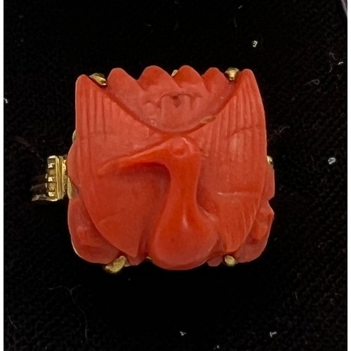 374 - A Chinese 14 carat yellow gold ring set with carved coral bird. Size M, weight 6.1gm.