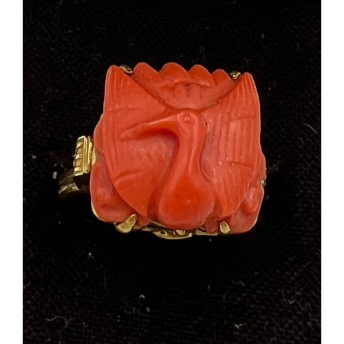 374 - A Chinese 14 carat yellow gold ring set with carved coral bird. Size M, weight 6.1gm.