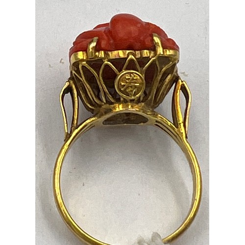 374 - A Chinese 14 carat yellow gold ring set with carved coral bird. Size M, weight 6.1gm.