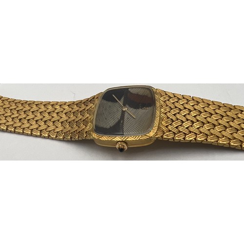 535 - An 18 carat gold Corum  bracelet watch with brown and cream feather dial, the winder set with a cabo... 