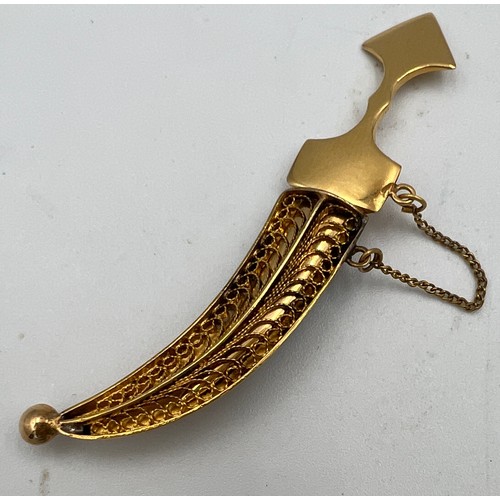 411 - A yellow metal dagger brooch, tests as approximately 14 carat gold. Lenght 6cm l. Weight 6gm.