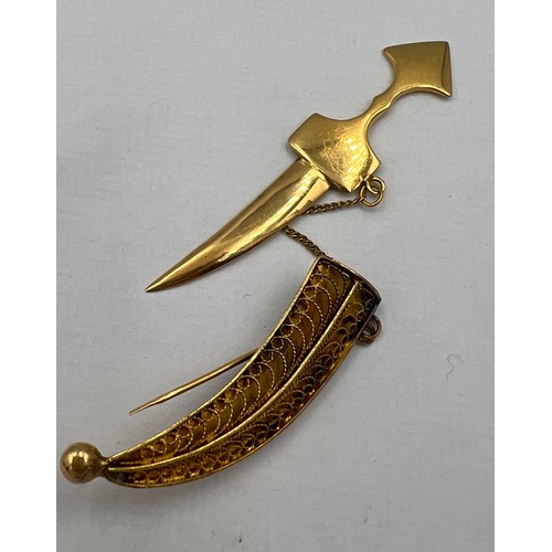 411 - A yellow metal dagger brooch, tests as approximately 14 carat gold. Lenght 6cm l. Weight 6gm.