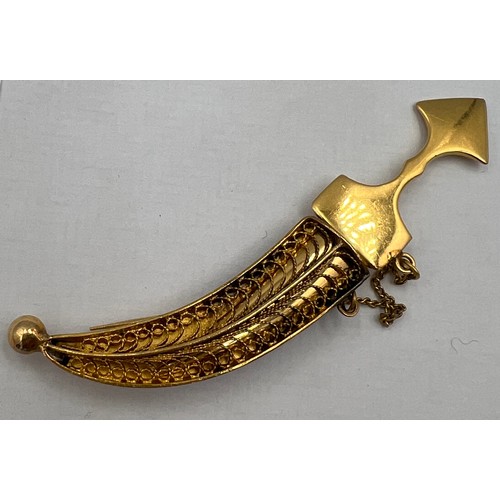 411 - A yellow metal dagger brooch, tests as approximately 14 carat gold. Lenght 6cm l. Weight 6gm.