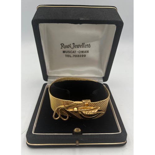 413 - A yellow metal bracelet in original presentation box. Length 22.5cm. Weight 69.3gm. Tests as approxi... 