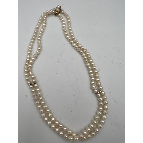 376 - A cultured pearl double row choker with a 9 carat gold clasp.  Approximately 34cm l.