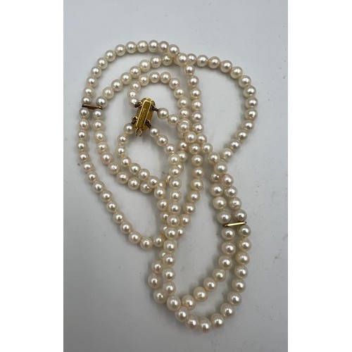 376 - A cultured pearl double row choker with a 9 carat gold clasp.  Approximately 34cm l.