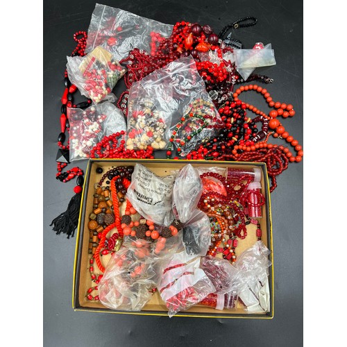 379 - A boxed lot of various red and black coloured glass beads.