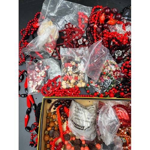 379 - A boxed lot of various red and black coloured glass beads.