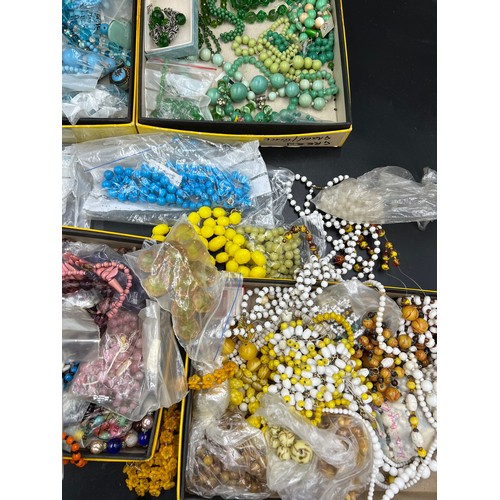 380 - A large collection of various vintage glass and other coloured beads. Some in need of re threading.