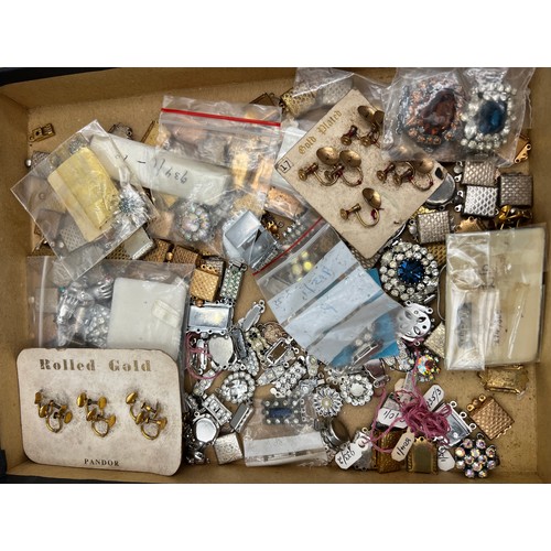 395 - A box of miscellaneous jewellery fastenings, brooch etc to include silver.