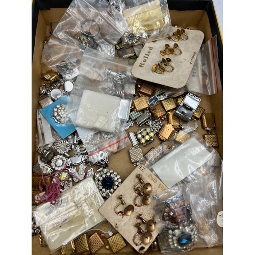 395 - A box of miscellaneous jewellery fastenings, brooch etc to include silver.