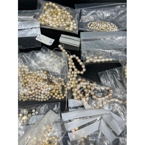 397 - A box of various cultured pearl necklaces and loose beads, most in need of re threading.