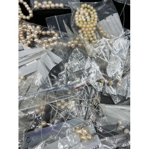 397 - A box of various cultured pearl necklaces and loose beads, most in need of re threading.