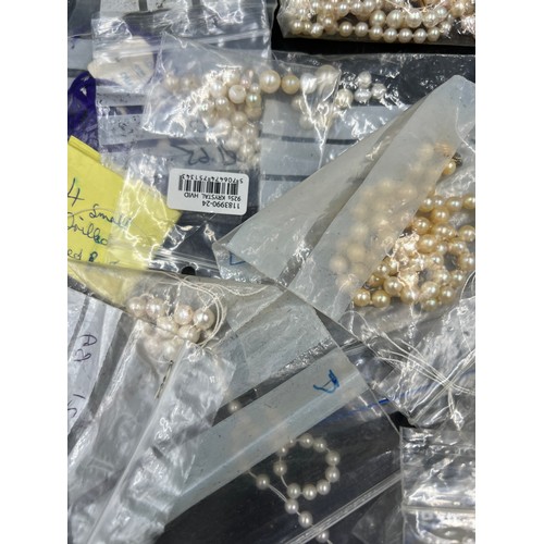 397 - A box of various cultured pearl necklaces and loose beads, most in need of re threading.