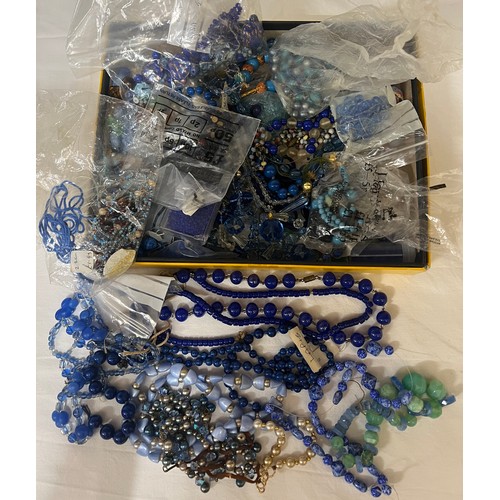 405 - A boxed quantity of vintage blue glass and other beads to include lapis.