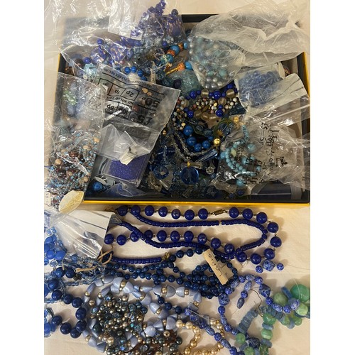 405 - A boxed quantity of vintage blue glass and other beads to include lapis.