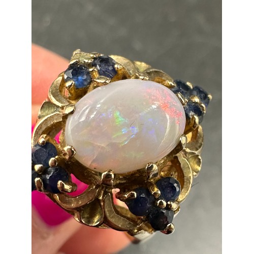 409 - A 9ct gold cluster ring set with central opal and sapphires 535gms, size P/Q.