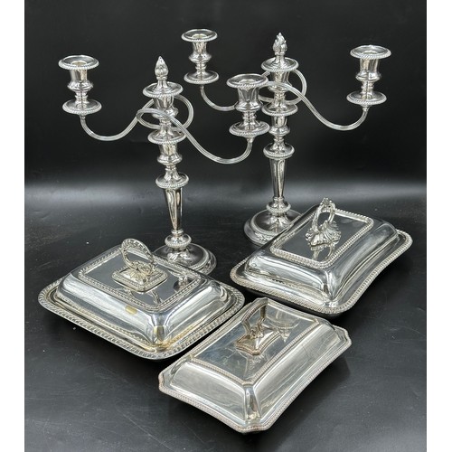 641 - Five silverplate items to include a pair of candelabras and three lidded tureens. To include one by ... 