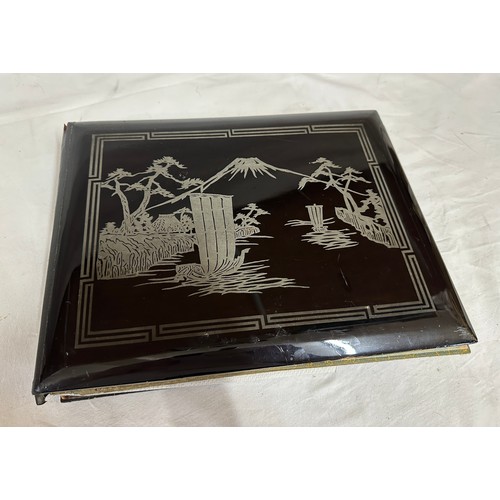 768 - An Oriental Lacquer Postcard Album containing Japanese and Chinese postcards of topographical views ... 