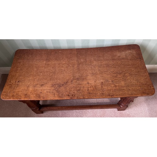 138 - A 1960's Robert Thompson Mouseman oak seat, curved rectangular top with adzed decoration, four carve... 