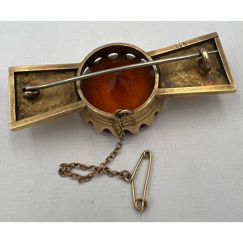 346 - A 9 carat gold brooch with safety chain set with cairngorm Approximately 6cm l. Total weight 24gm.