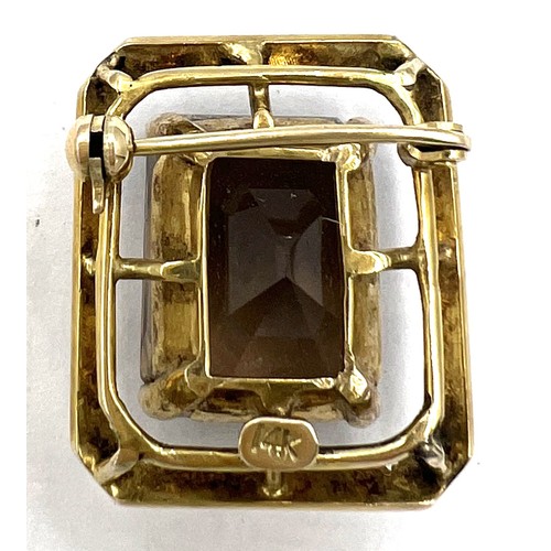 347 - A Smokey quartz brooch set in 14 carat gold. Size approximately 2cm x 2.2cm. Weight 8.3gm.