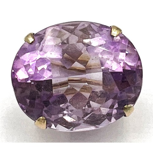 348 - A yellow metal brooch set with amethyst. Approximate size 2.3cm x 2cm. Weight 10.1gm.