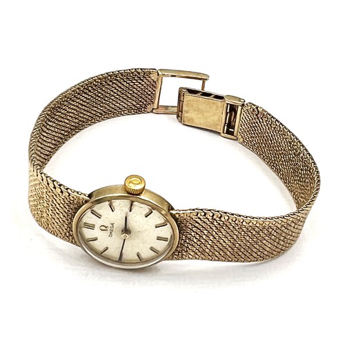 538 - A ladies 9 carat gold Omega wristwatch with 9 carat gold strap and Omega clasp. Total weight 26.4gm.