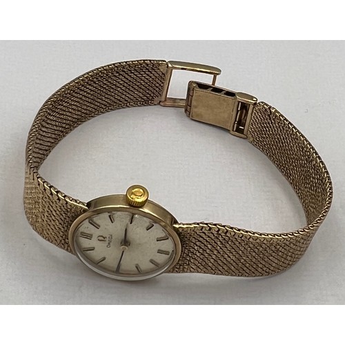 538 - A ladies 9 carat gold Omega wristwatch with 9 carat gold strap and Omega clasp. Total weight 26.4gm.