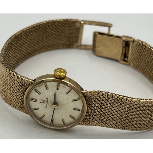 538 - A ladies 9 carat gold Omega wristwatch with 9 carat gold strap and Omega clasp. Total weight 26.4gm.